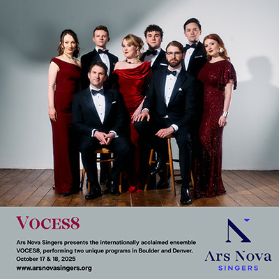 eight singers in elegant formal clothing stand together on a wooden floor