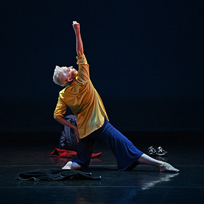 woman wearing yellow and blue doing a contemporary dance