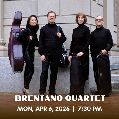 Brentano quartet standing in front of a building, holding instruments