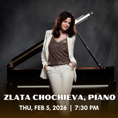 Zlata Chochieva standing in front of a piano