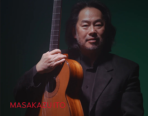 Masakazu Ito holding a guitar