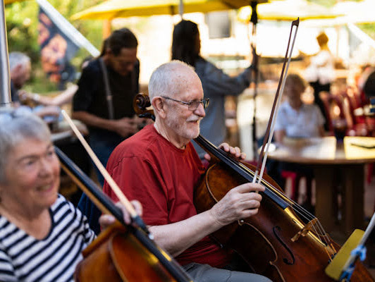 two cellists playing outside
